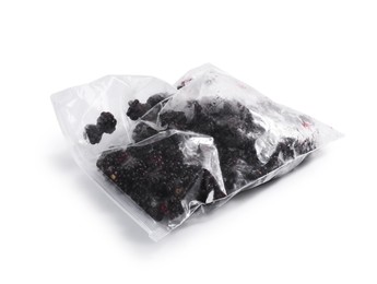 Photo of Ripe frozen blackberries in plastic bag isolated on white