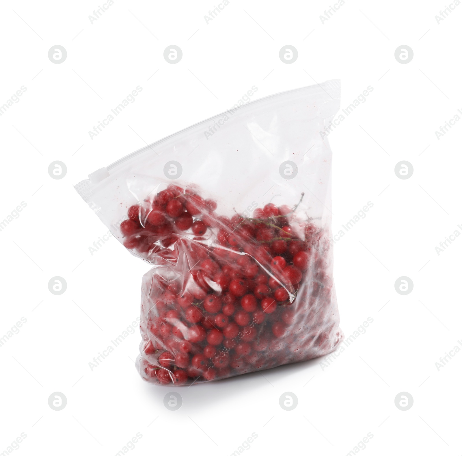 Photo of Ripe frozen red currants in plastic bag isolated on white