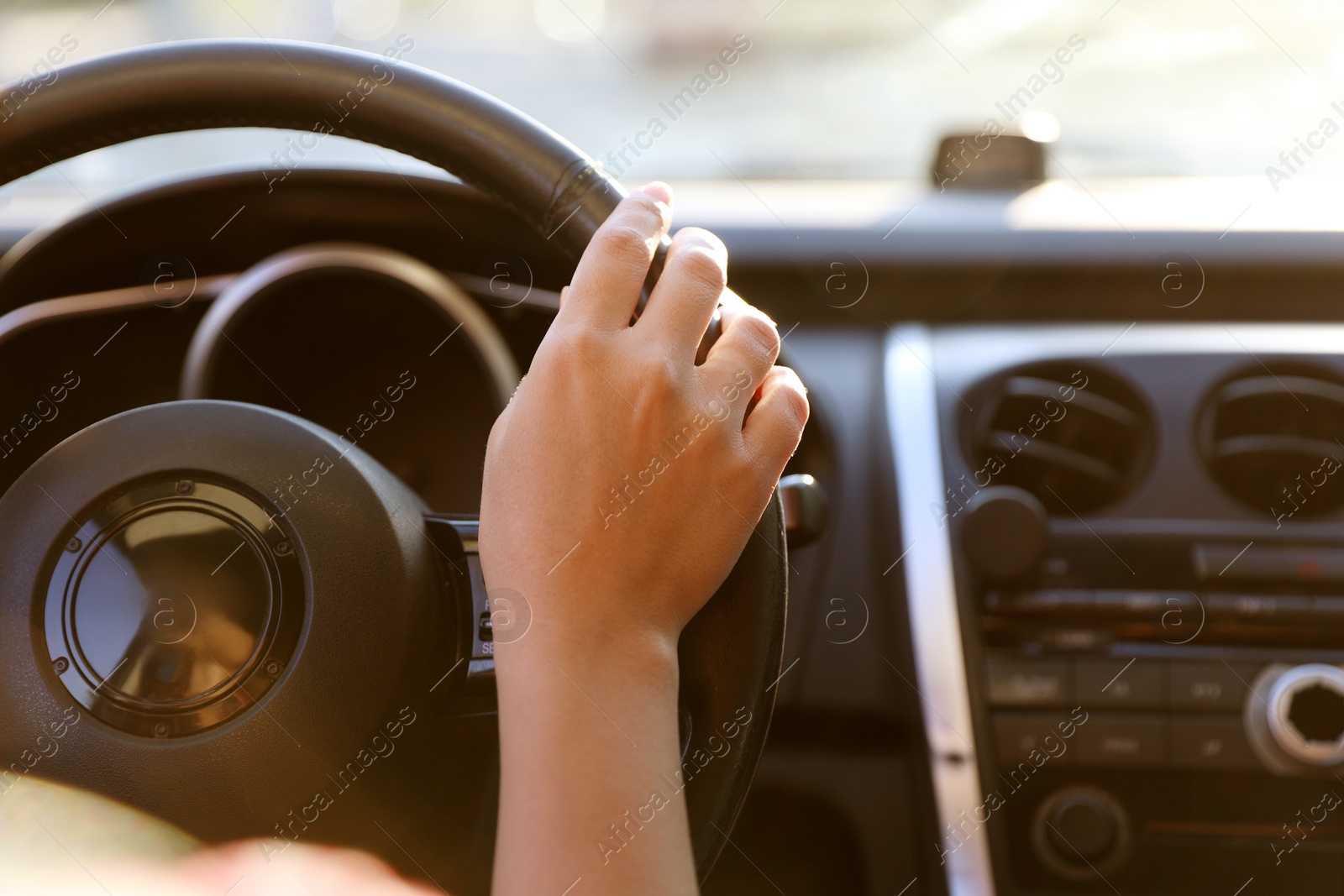Woman behind steering wheel of modern car, closeup Photo of Woman behind steering wheel of modern car, closeup
