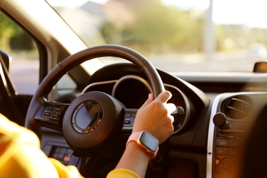 Photo of Woman behind steering wheel of modern car, closeup