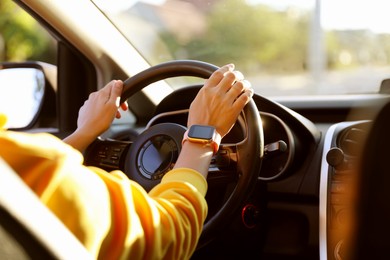 Photo of Woman behind steering wheel of modern car, closeup