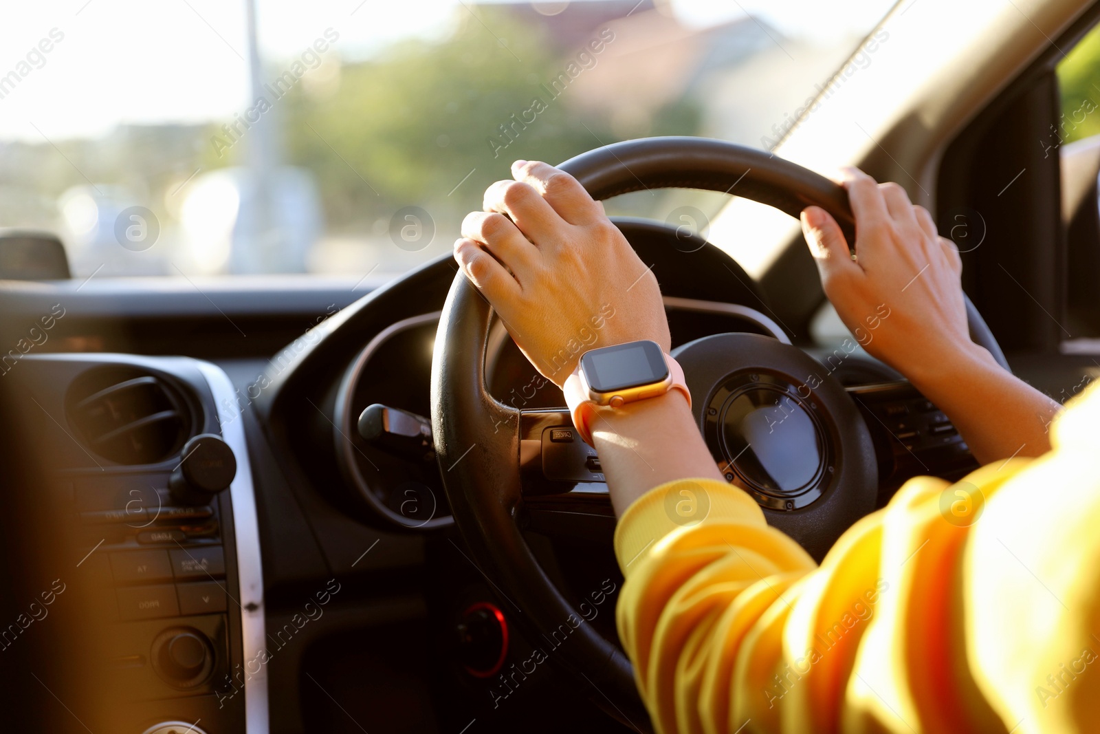 Woman behind steering wheel of modern car, closeup Photo of Woman behind steering wheel of modern car, closeup