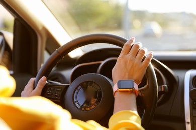 Photo of Woman behind steering wheel of modern car, closeup