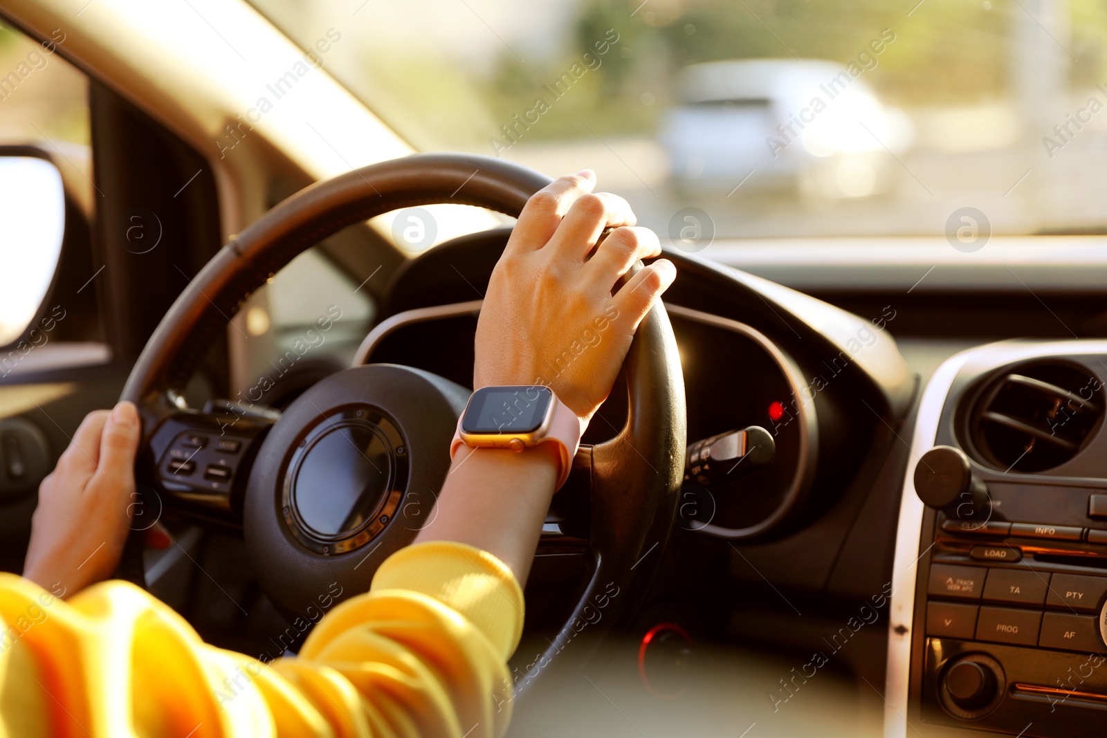 Woman behind steering wheel of modern car, closeup Photo of Woman behind steering wheel of modern car, closeup