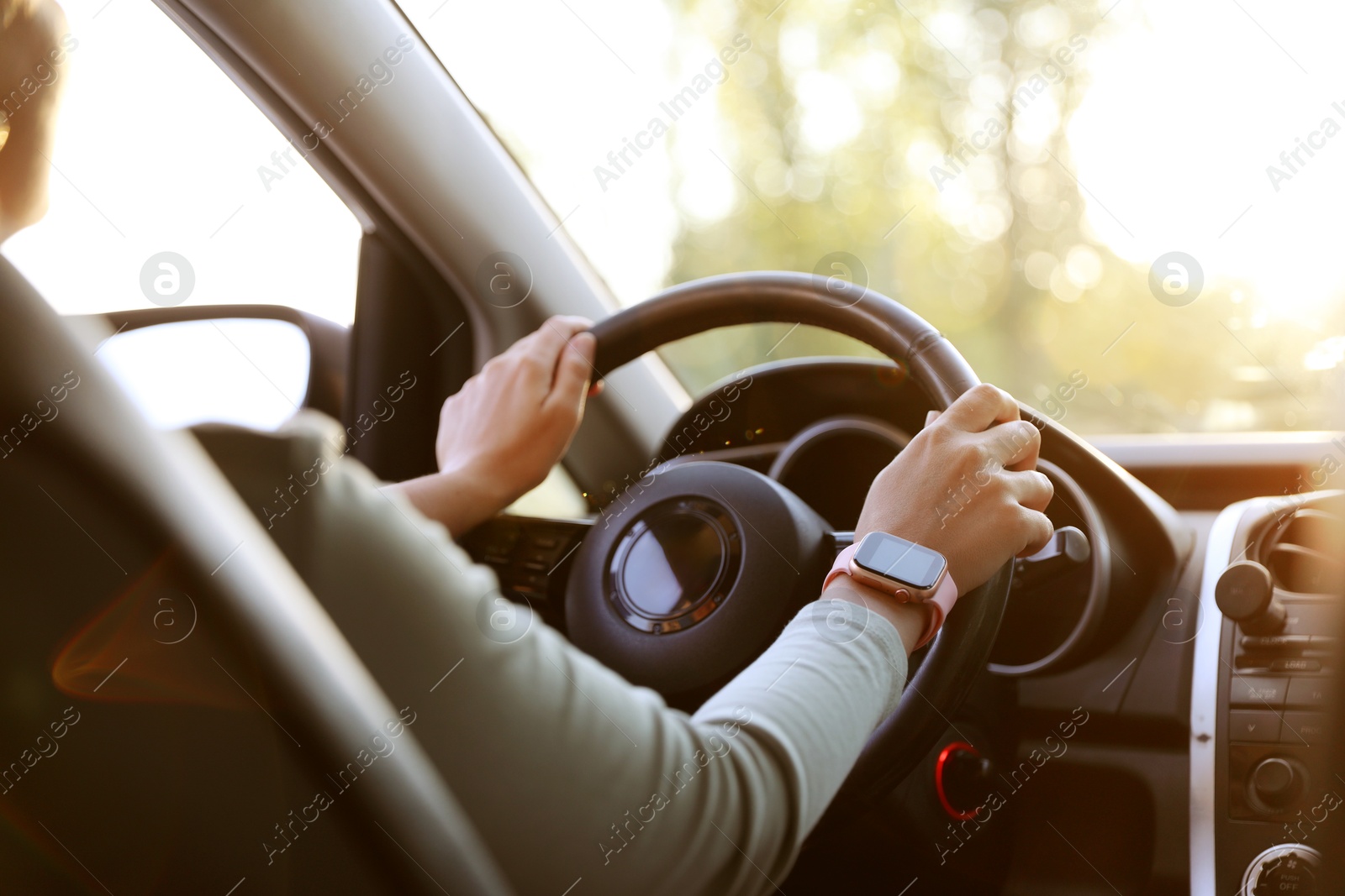 Woman behind steering wheel of modern car, closeup Photo of Woman behind steering wheel of modern car, closeup