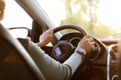 Photo of Woman behind steering wheel of modern car, closeup