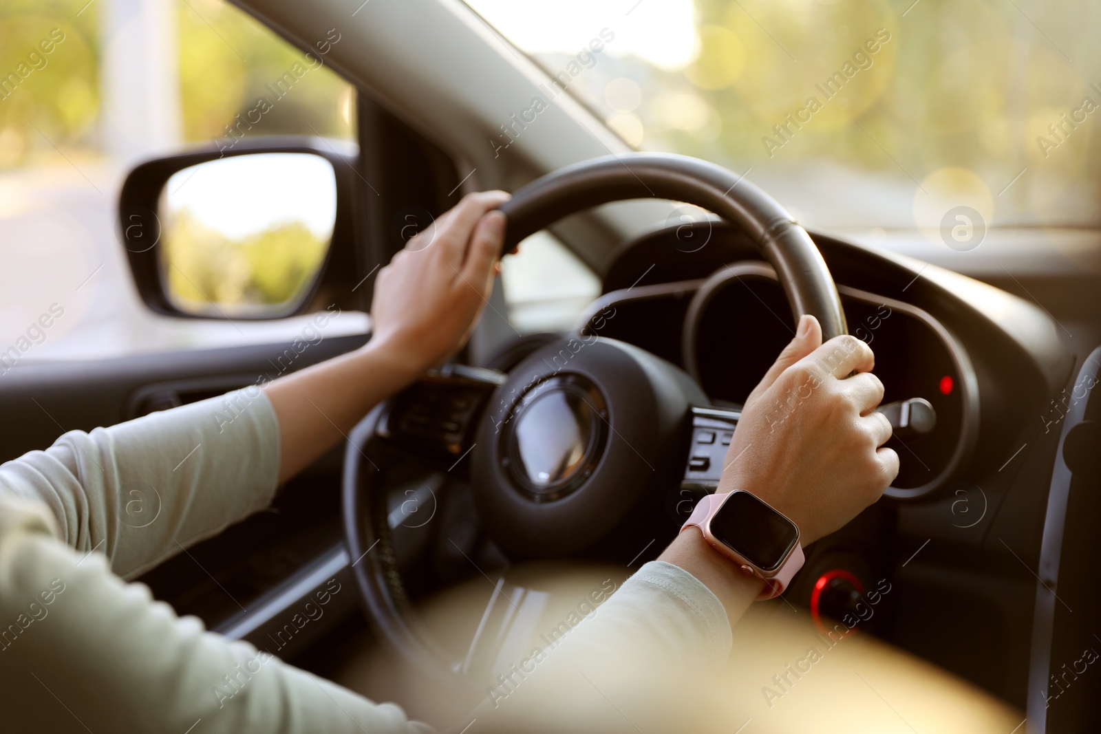 Woman behind steering wheel of modern car, closeup Photo of Woman behind steering wheel of modern car, closeup