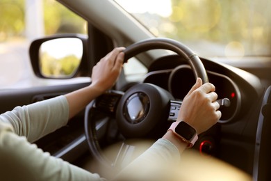 Photo of Woman behind steering wheel of modern car, closeup