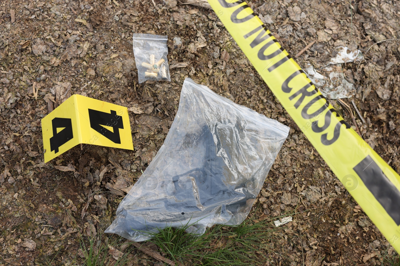 Forensic expertise. Crime scene with evidence, marker and police tape outdoors, above view Photo of Forensic expertise. Crime scene with evidence, marker and police tape outdoors, above view