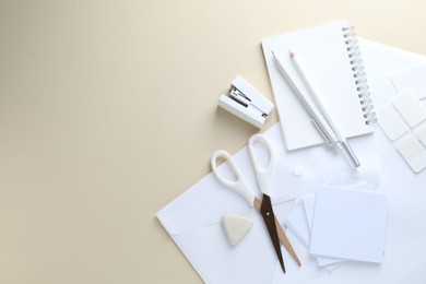 Photo of White stationery on beige background, flat lay. Space for text