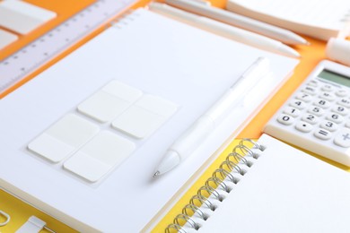 Photo of Stationery in white color on bright background, closeup