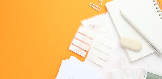 Photo of White stationery on orange background, flat lay. Banner design with space for text