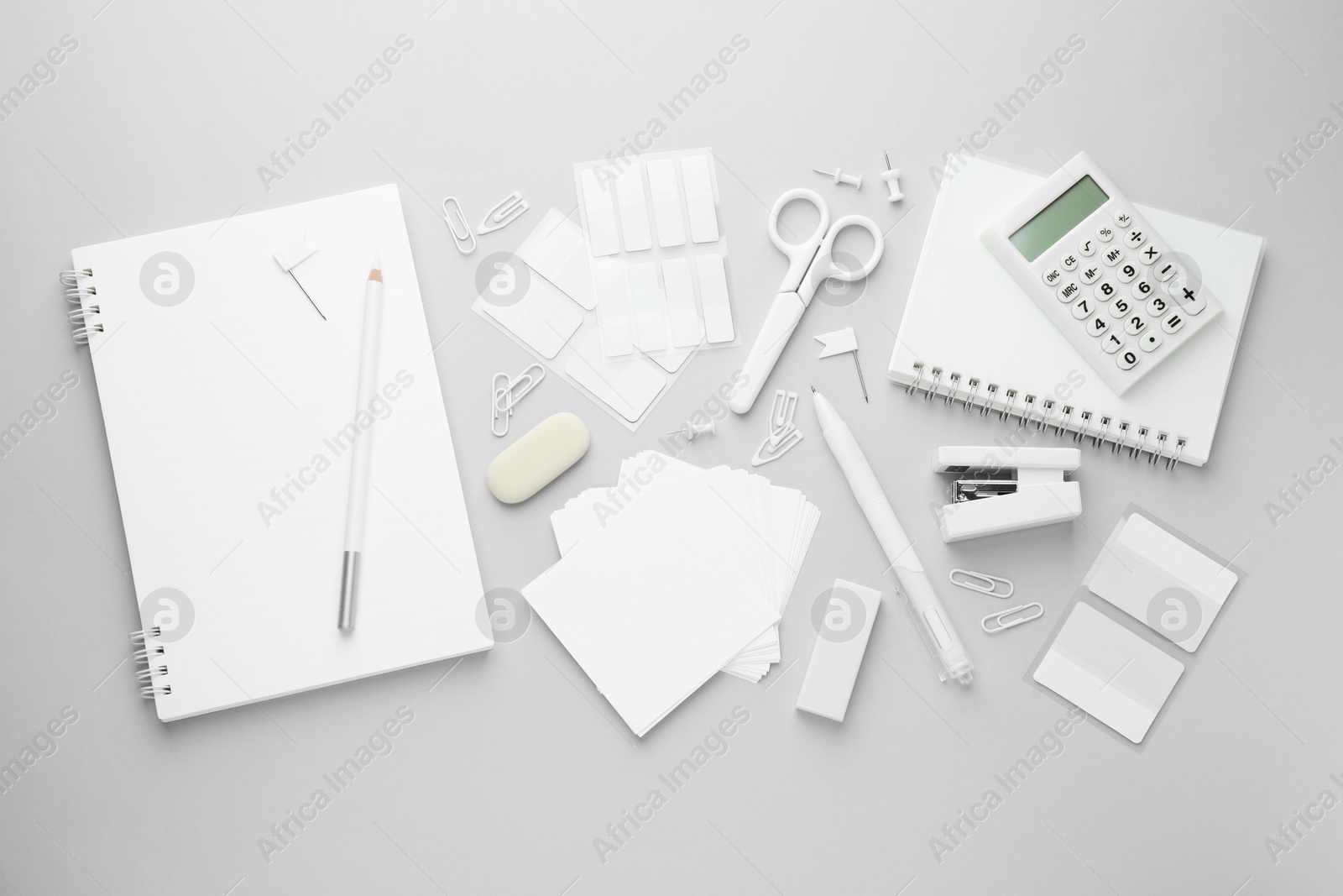 Photo of White stationery on light grey background, flat lay