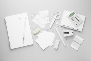 Photo of White stationery on light grey background, flat lay