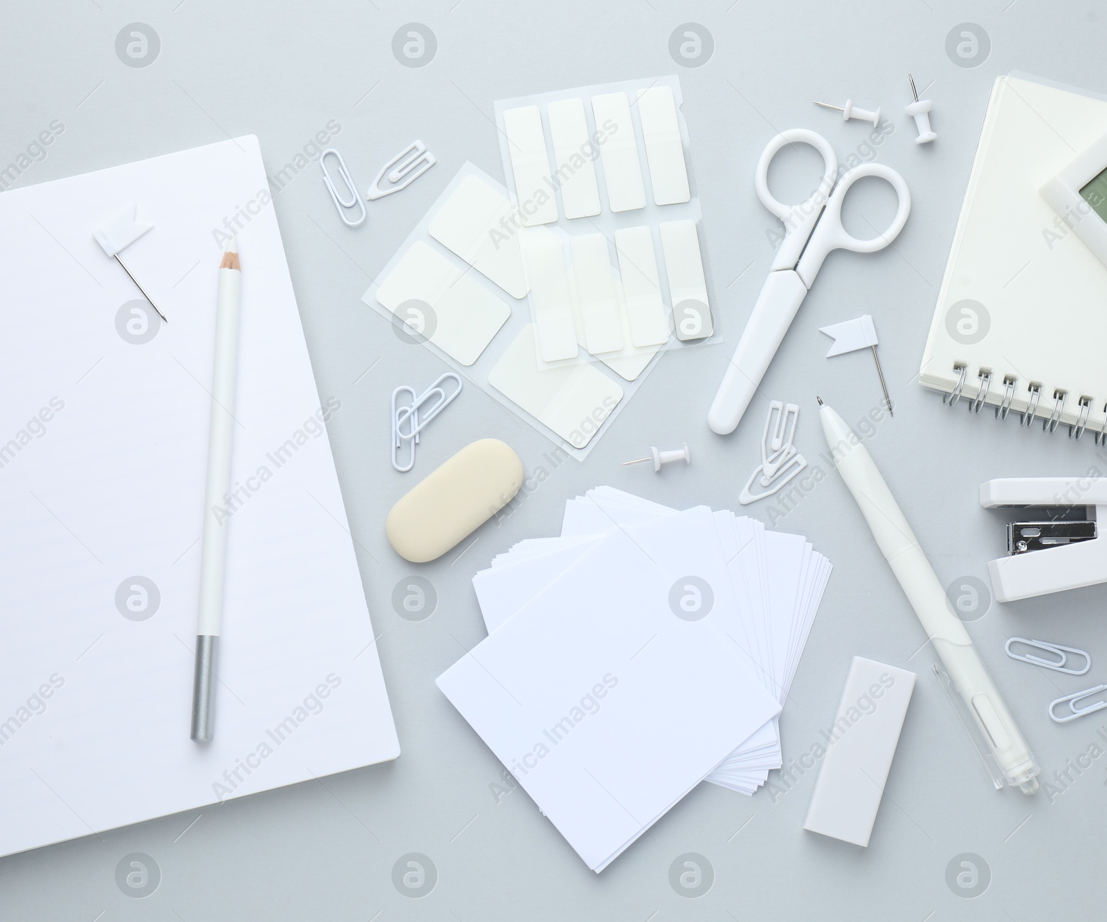 Photo of White stationery on light grey background, flat lay