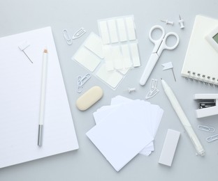 Photo of White stationery on light grey background, flat lay