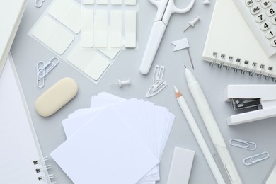 Photo of White stationery on light grey background, flat lay