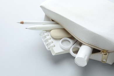 Photo of White stationery on light grey background, closeup