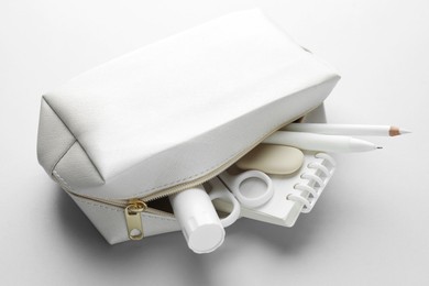 Photo of White stationery on light grey background, closeup