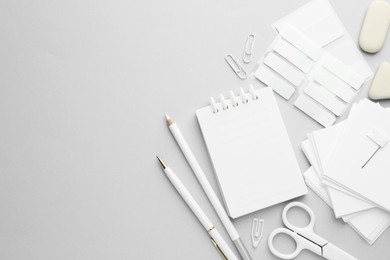 Photo of White stationery on light grey background, flat lay. Space for text