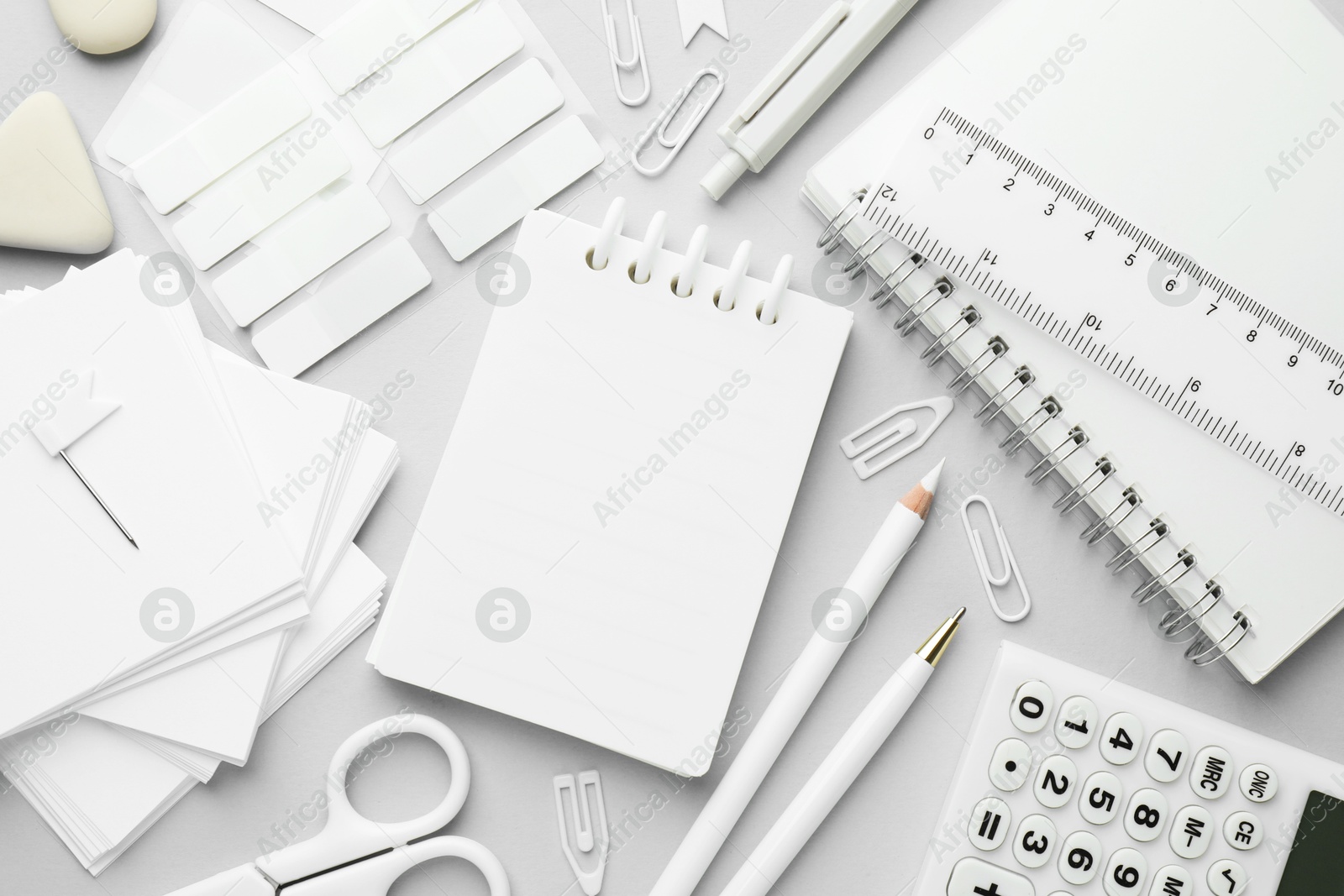 Photo of White stationery on light grey background, flat lay