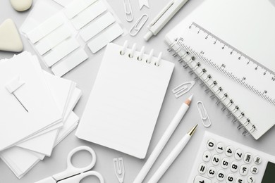 Photo of White stationery on light grey background, flat lay