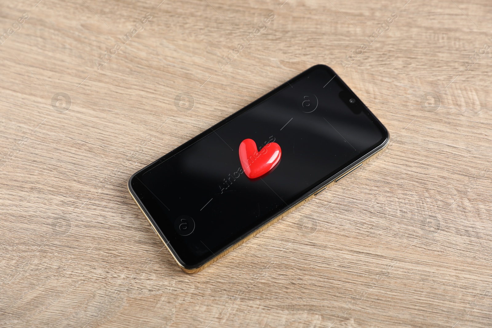 Photo of Online dating site. Smartphone and red heart on wooden table, above view