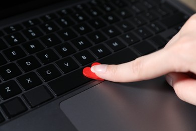 Photo of Online dating site. Woman touching red heart on laptop, closeup