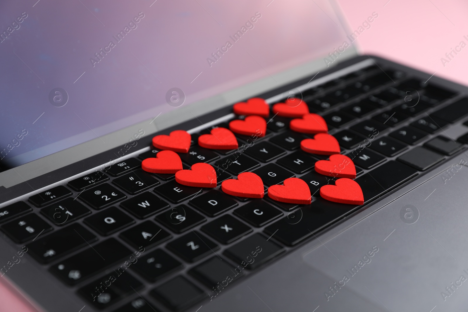 Online dating site. Many red hearts on laptop, closeup Photo of Online dating site. Many red hearts on laptop, closeup
