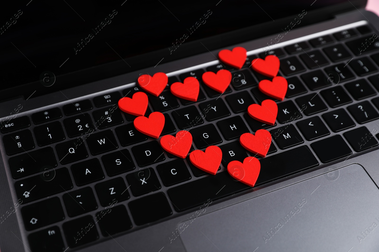 Online dating site. Many red hearts on laptop, closeup Photo of Online dating site. Many red hearts on laptop, closeup