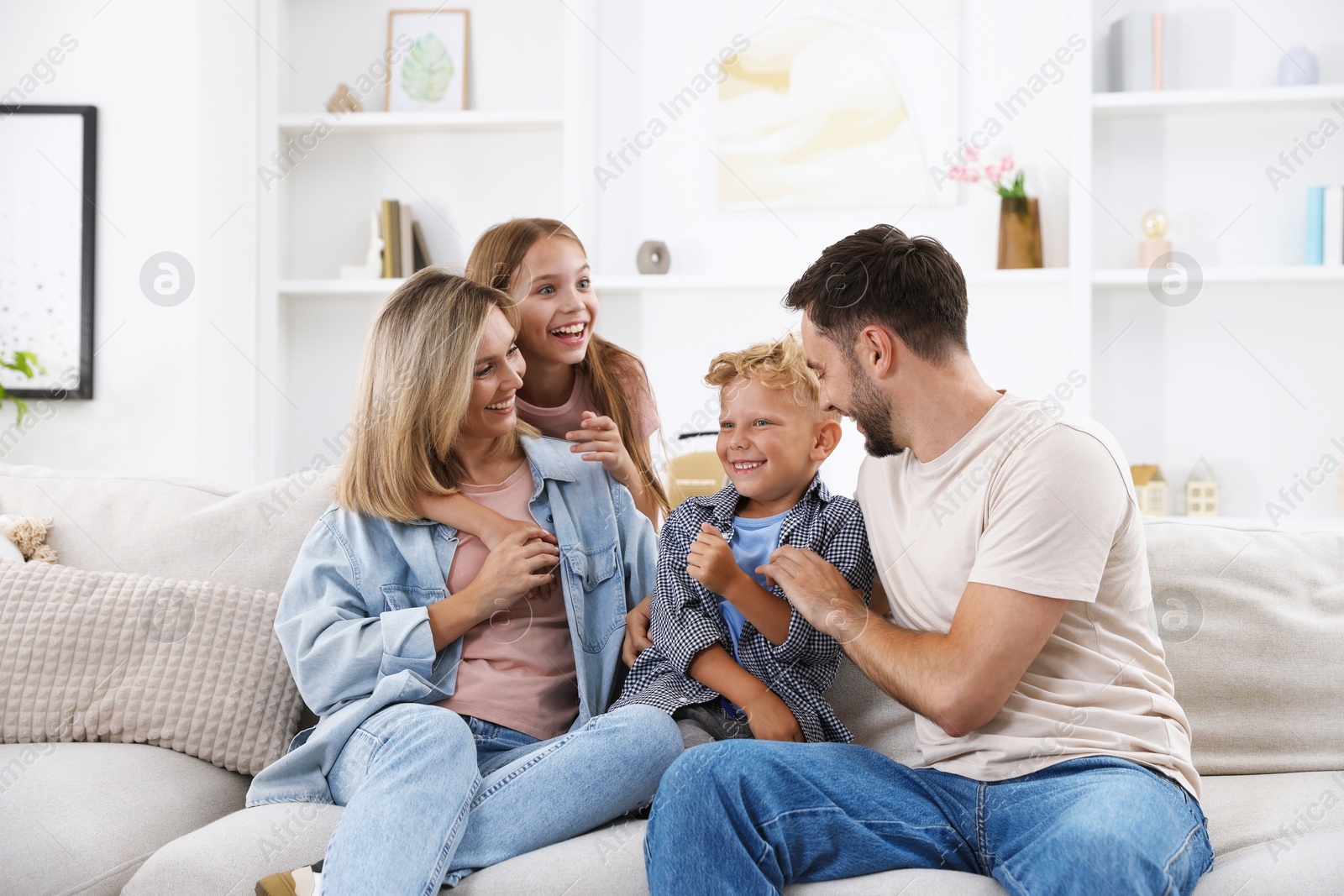Photo of Happy family spending time together on sofa at home
