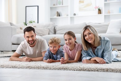 Photo of Happy family posing on floor at home