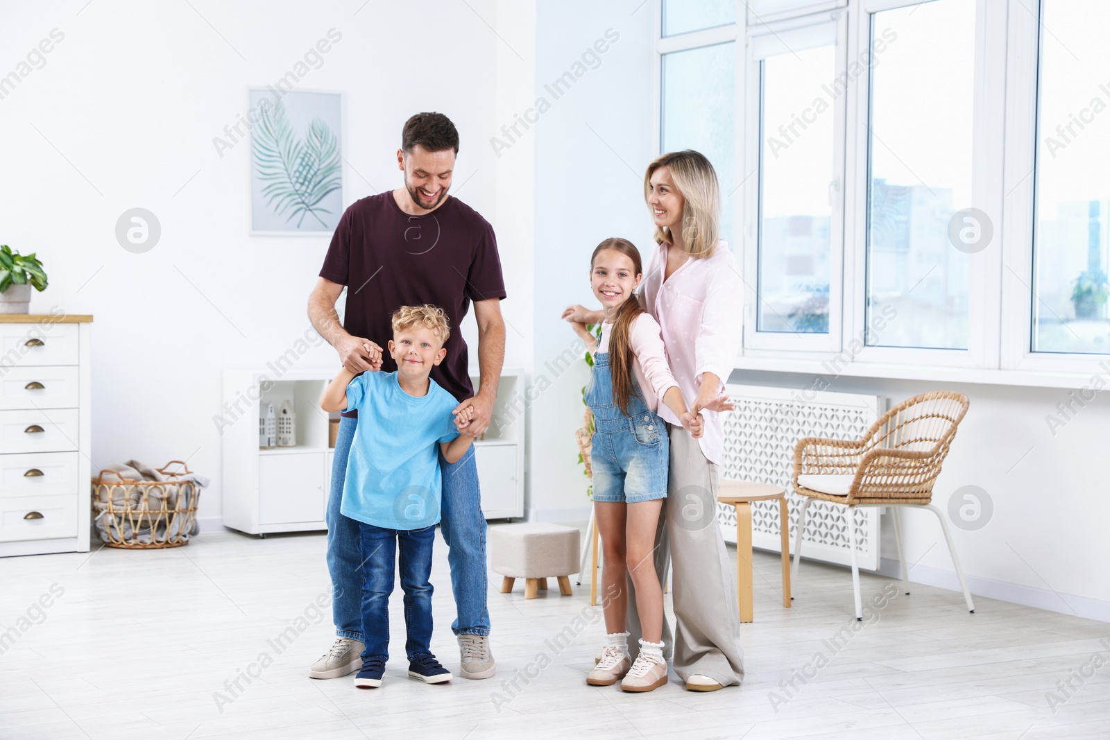 Photo of Happy family spending time together in light room
