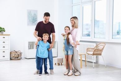 Photo of Happy family spending time together in light room