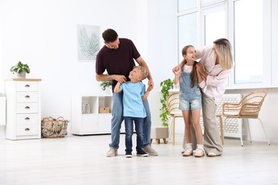 Photo of Happy family spending time together in light room