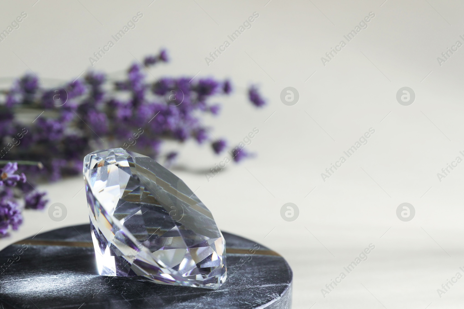 Aura. Beautiful diamond and lavender flowers on beige background, closeup. Space for text Photo of Aura. Beautiful diamond and lavender flowers on beige background, closeup. Space for text