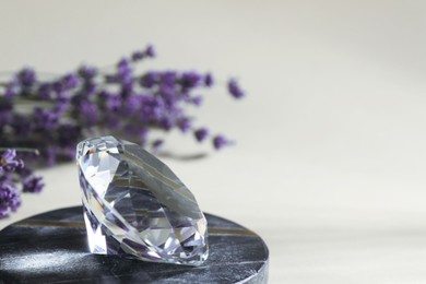 Photo of Aura. Beautiful diamond and lavender flowers on beige background, closeup. Space for text