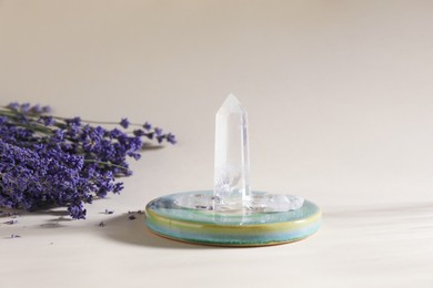Photo of Aura. Beautiful crystals and lavender flowers on beige background