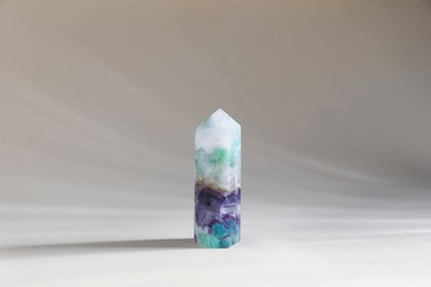 Photo of Aura. One beautiful crystal on beige background
