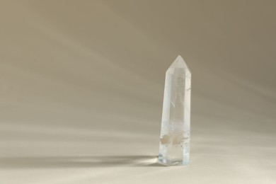Photo of Aura. Beautiful crystal on beige background. Space for text