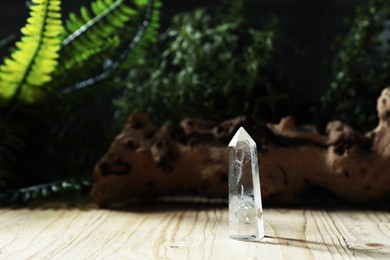 Photo of Aura. Beautiful crystal on wooden surface outdoors. Space for text