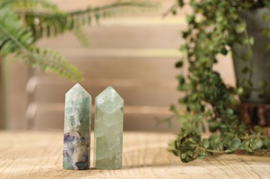 Photo of Aura. Beautiful crystals on wooden surface indoors