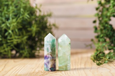 Photo of Aura. Beautiful crystals on wooden surface indoors