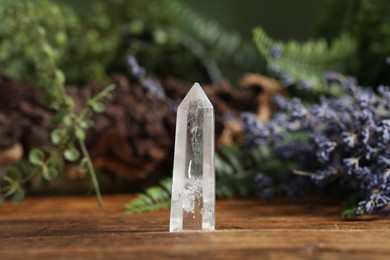 Photo of Aura. Beautiful crystal on wooden surface outdoors