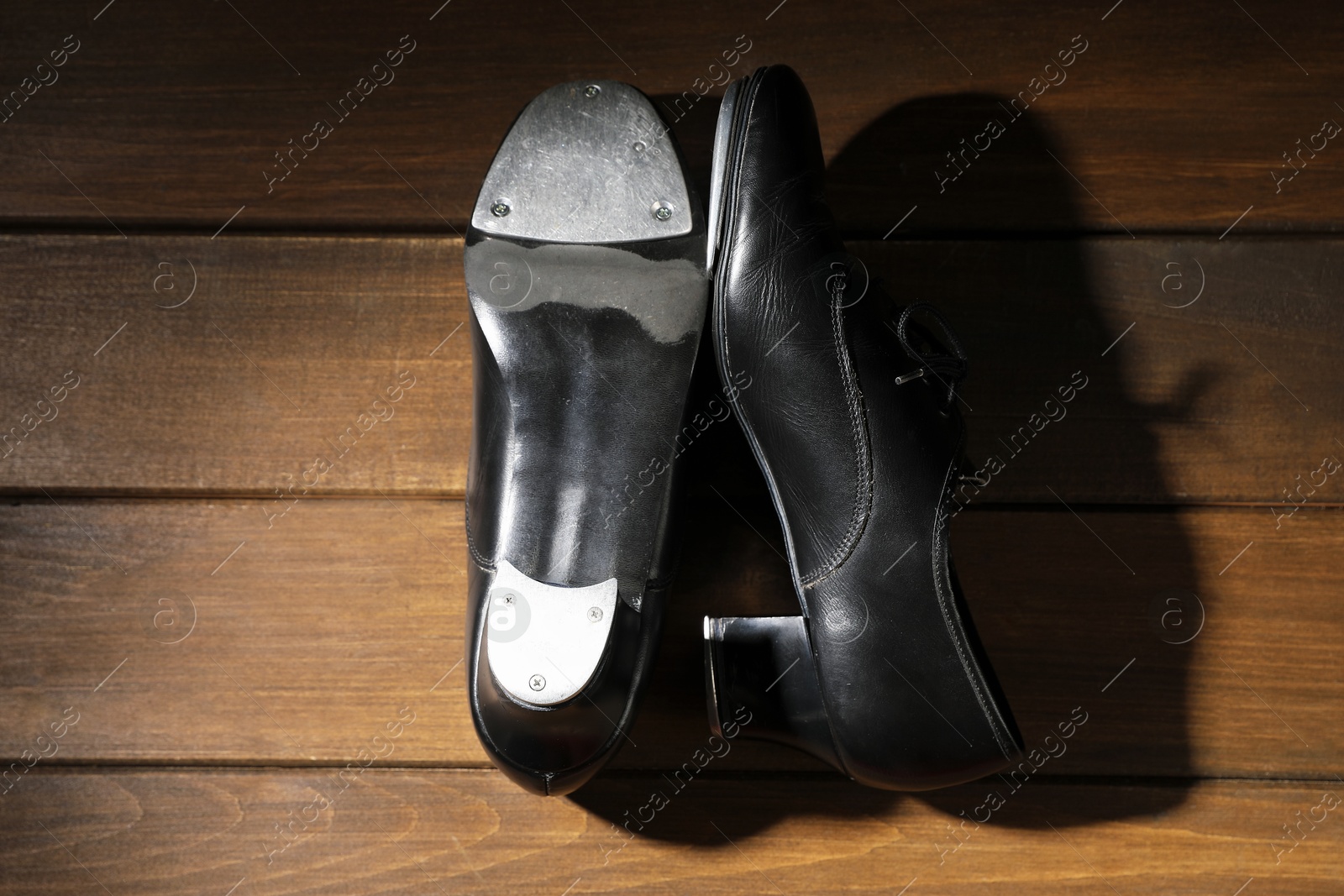 Pair of tap shoes on wooden floor, top view. Tap dance Photo of Pair of tap shoes on wooden floor, top view. Tap dance