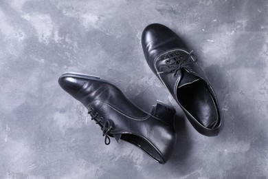 Photo of Pair of tap shoes on grey surface, top view. Tap dance