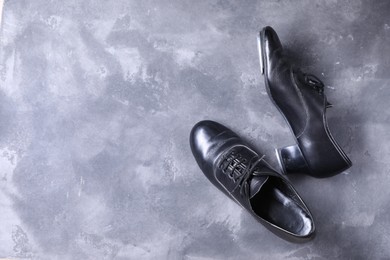 Photo of Pair of shoes for tap dance on grey surface, top view. Space for text