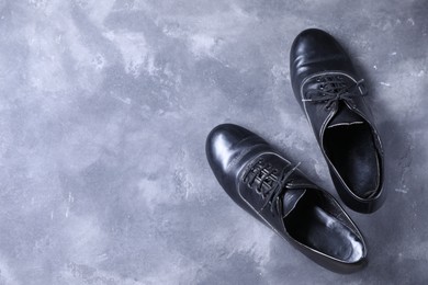 Photo of Pair of shoes for tap dance on grey surface, top view. Space for text