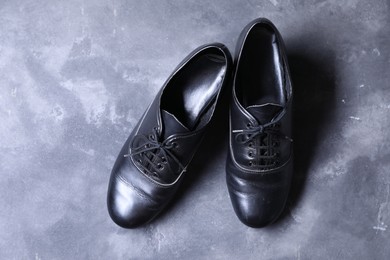 Photo of Pair of tap shoes on grey surface, top view. Tap dance