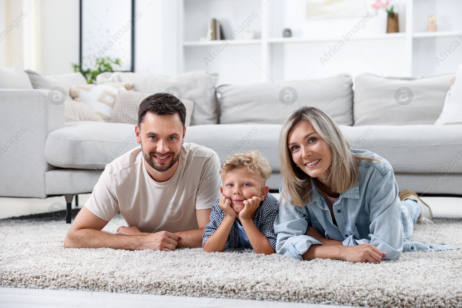 Photo of Happy family posing on floor at home